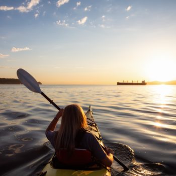 aquafit | woman paddling a canoe on a lake