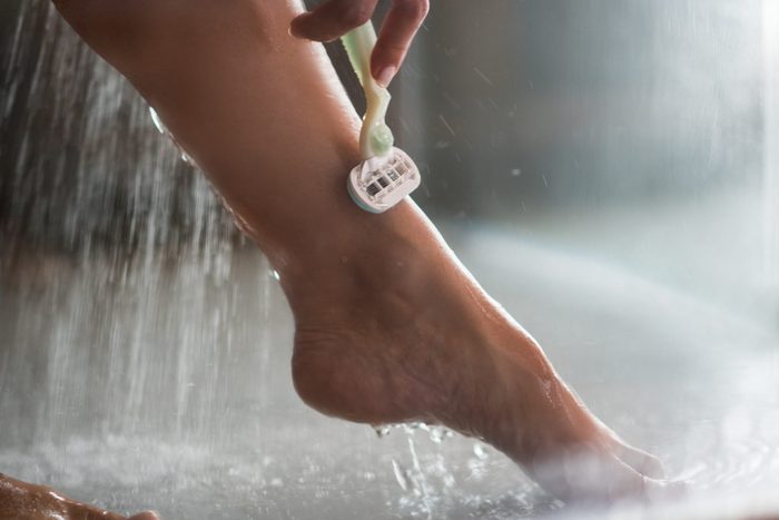 Close Up Of Unrecognizable Woman Shaving Her Leg Under The Shower 3