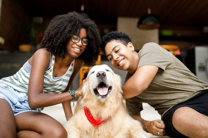 Two Teenagers With Their Dog