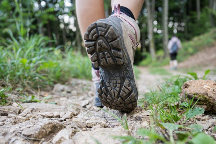 hiking shoes for women | Low Section Of Person Walking On Field