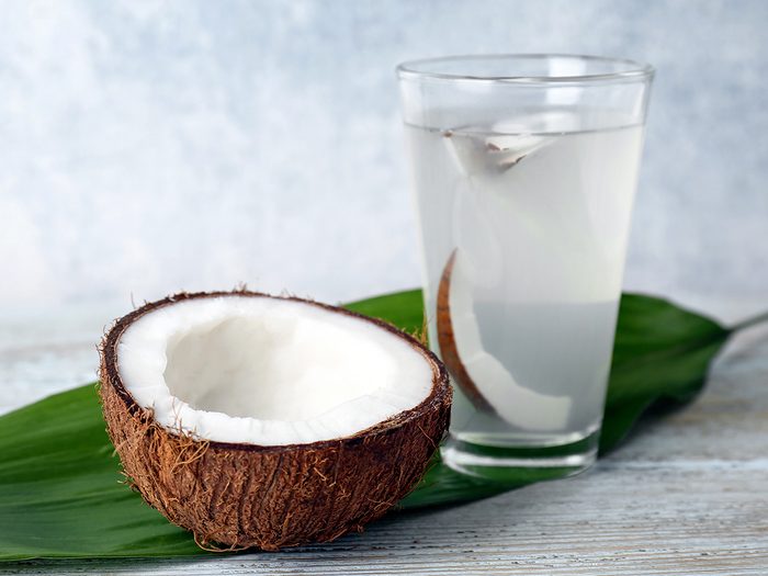 Glass,of,coconut,water,with,nut,on,wooden,background