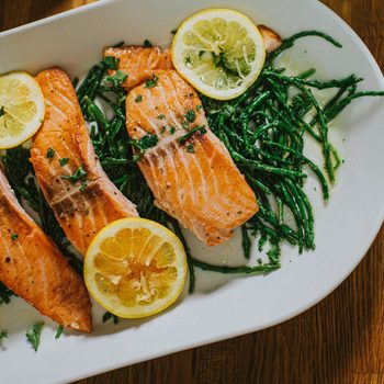 salmon benefits | Salmon On A Serving Plate On A Table