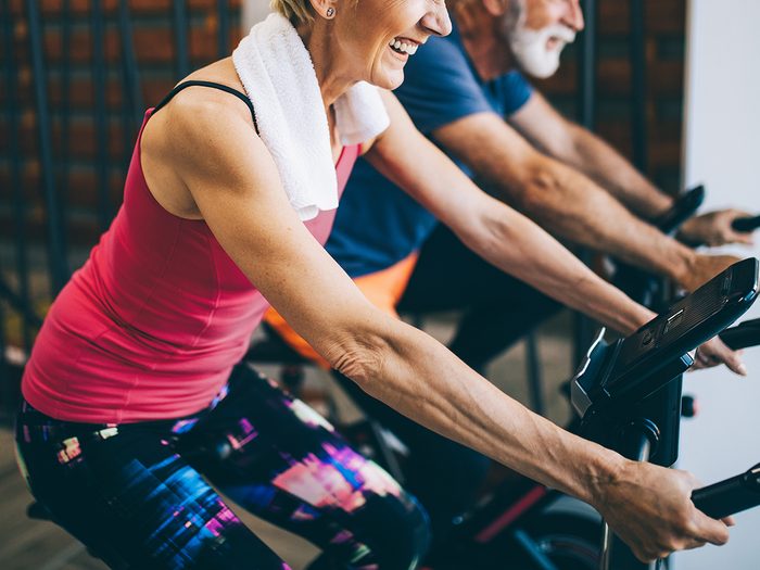 best exercise bikes for seniors | Happy,fit,mature,woman,and,man,cycling,on,exercise,bikes