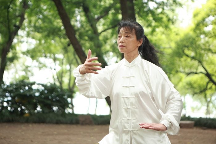 tai chi exercise | woman doing tai chi exercise in the park