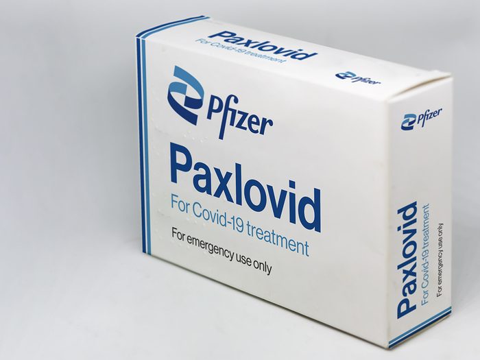 Photo of a box of Pfizer's COVID antiviral pill, Paxlovid on a plain background