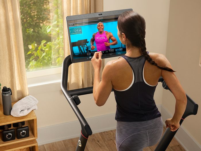 Peloton Treadmill Canada: photo of a woman on the Peloton Tread in her home during a class