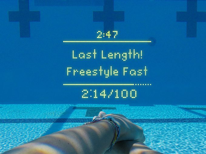 A photograph of what it looks like to wear FORM swimming goggles underwater with the display saying "last length!"