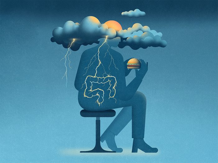 Nutritional psychology: An illustration of a figure sitting on chair about to eat a burger with a storm brewing near their head connected to their digestive tract, meant to illustrate the mind-gut connection.
