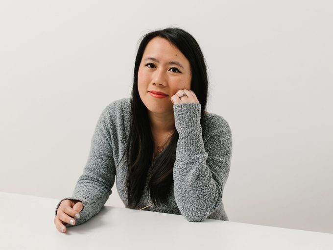 Photograph of Amy Chow looking directly at the camera wearing a grey sweater and smiling. Digestive Disorder Symptoms Women Diagnosis Canada Amy By Rachel Pick
