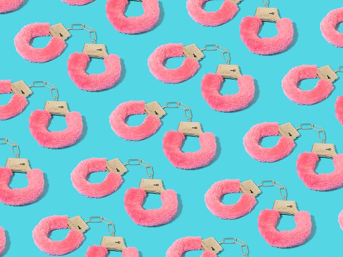 Colorful,pattern,with,pink,furry,handcuffs,on,serenity,pastel,blue
