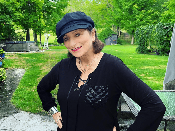 jeanne beker breast cancer | jeanne beker wearing an all black outfit standing by a green lawn