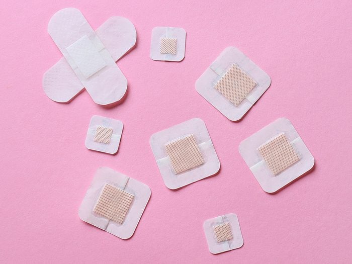 Different,adhesive,plasters,on,pink,background