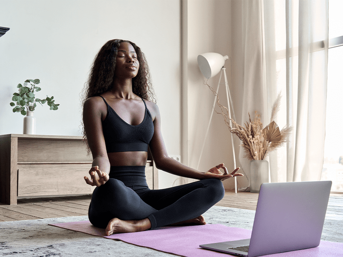 Do Meditiation Apps Work Hero | woman meditating on a yoga mat
