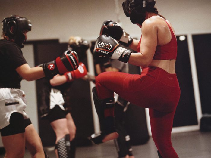 people sparring and practicing kickboxing at a SHEspars event | kickboxing
