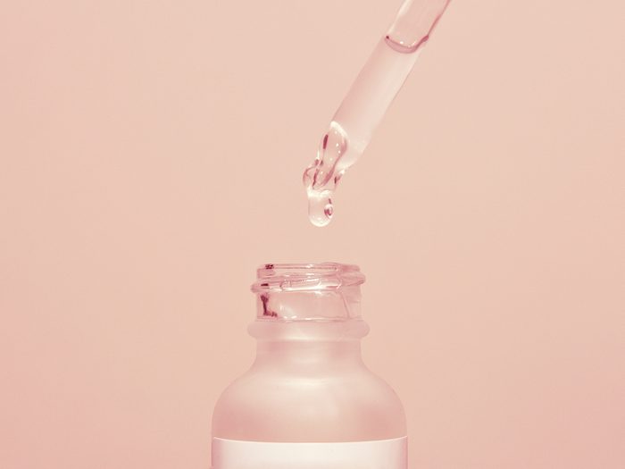 azelaic acid | Face,serum,drop,with,bottle,on,pink,background.