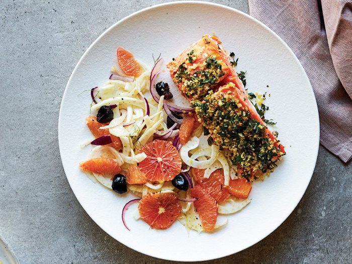 salmon on a white plate with citrus salad