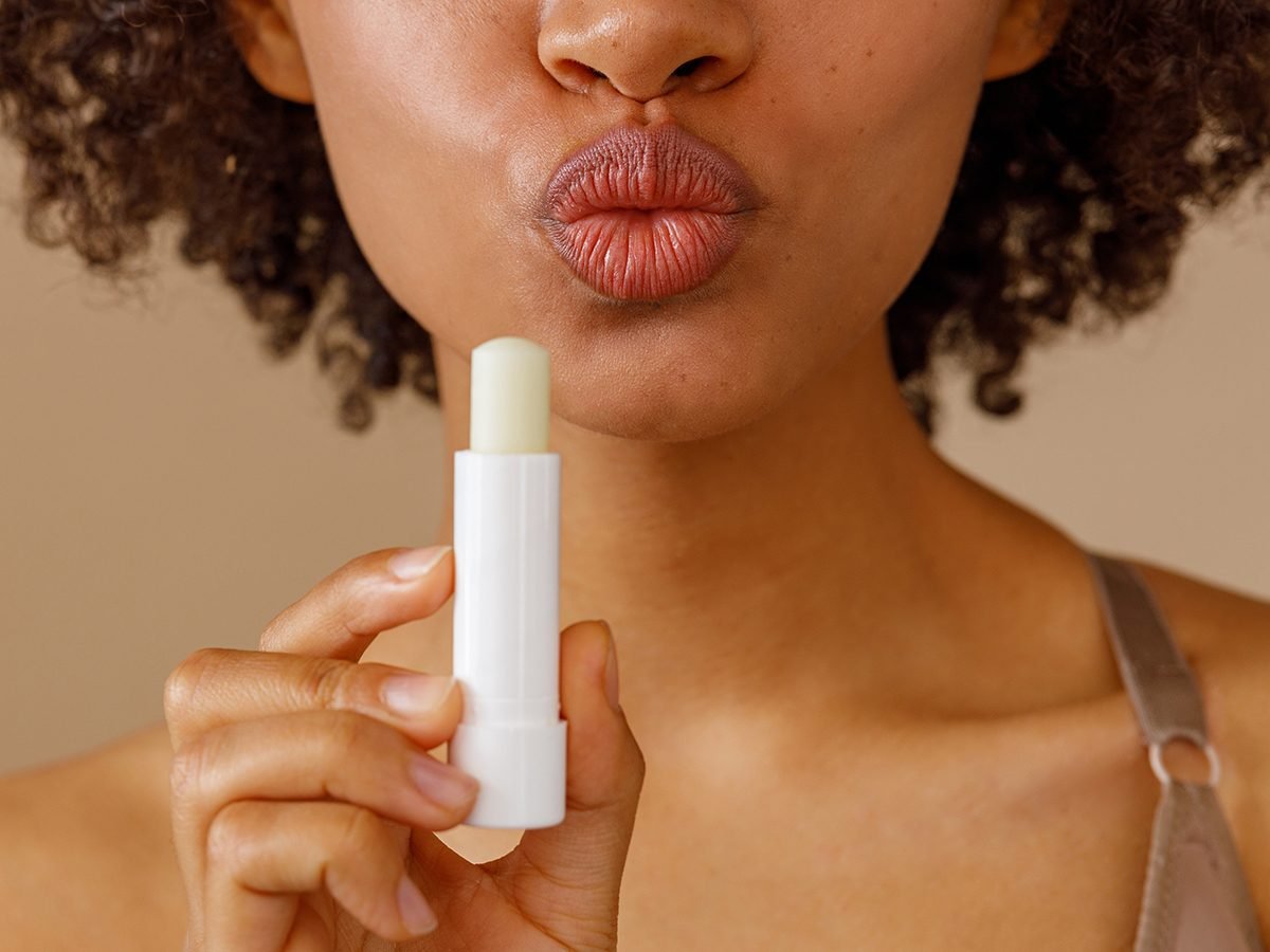 Picture,of,beautiful,woman,with,lip,balm,,indoors